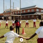 Children playing soccer during a community sports session